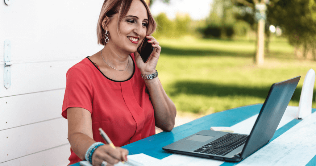 Female Entrepreneur working on her laptop outside on a nice, sunny day. 