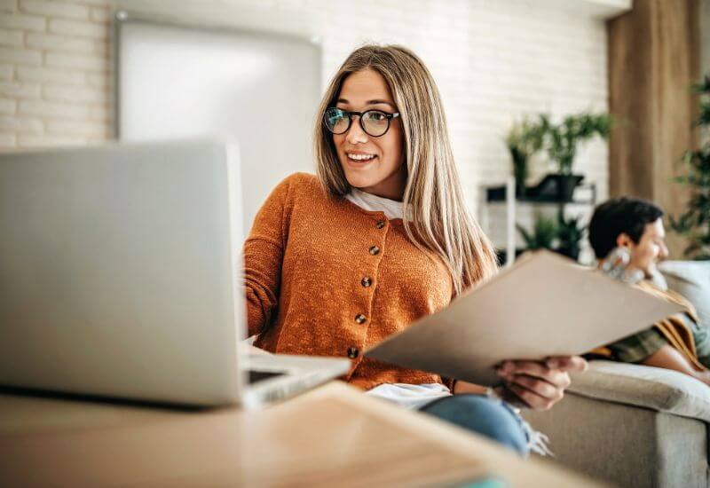 A woman working from home at her laptop on a membership site.